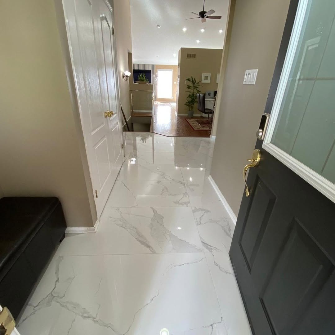 Front foyer finished with white marble-pattern porcelain tile