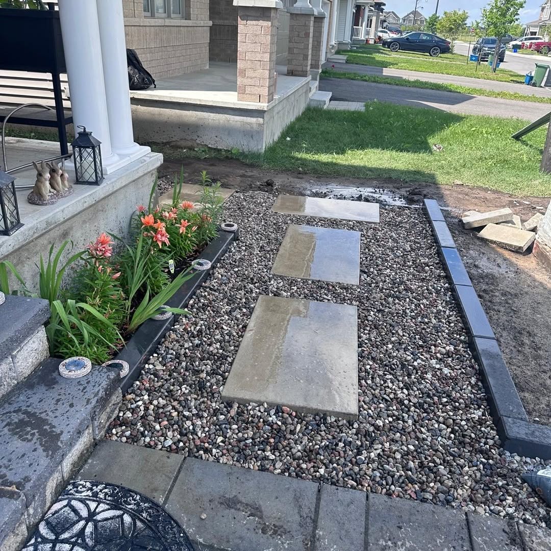 Front yard walkway with stone slabs set in pebble bed and interlock border