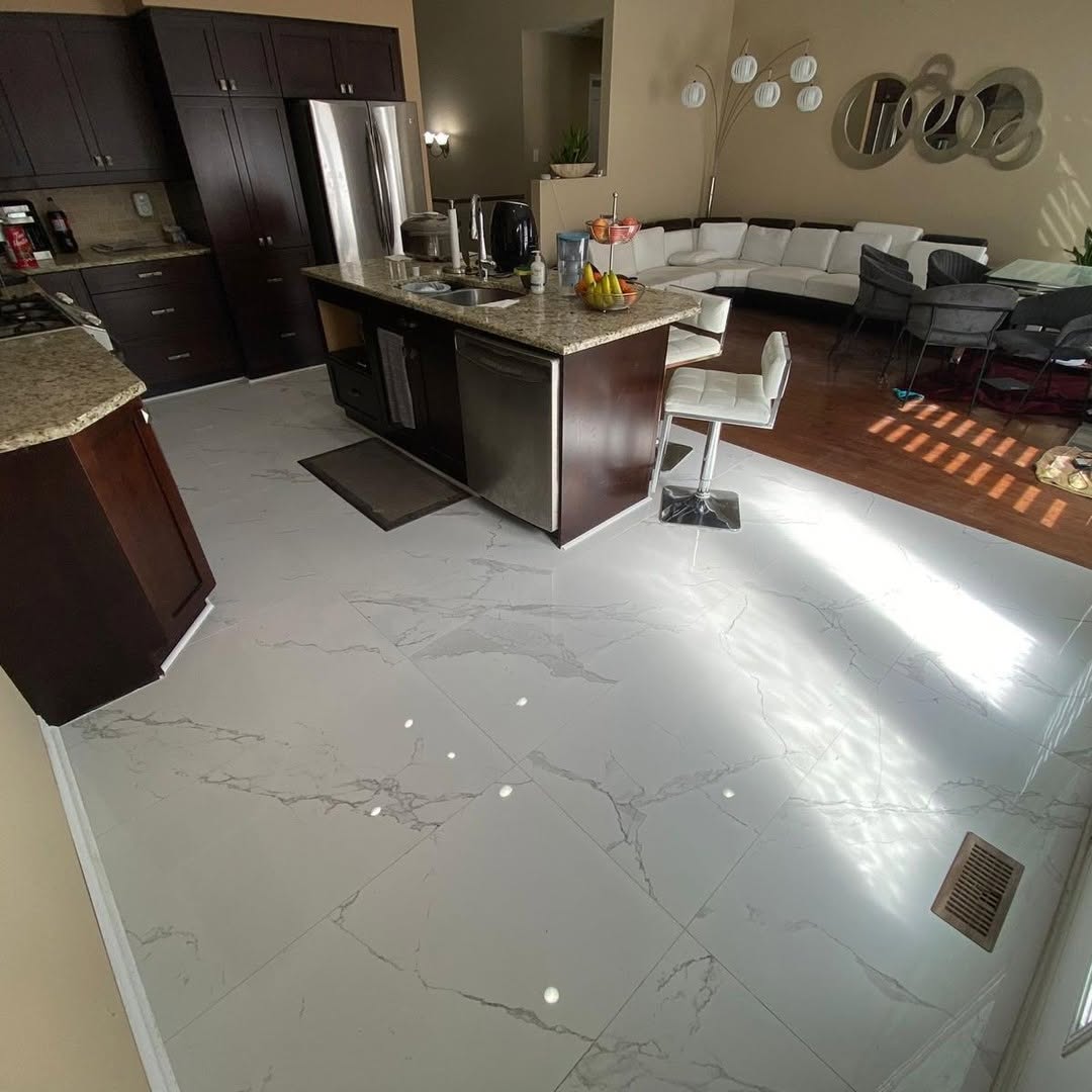 Open-concept kitchen with large-format marble-look porcelain flooring and dark espresso cabinetry
